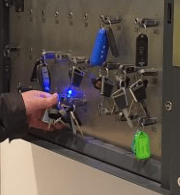 man pulling out a key from electronic key cabinet
